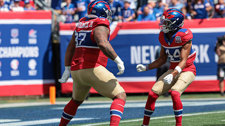 Sep 8, 2024; East Rutherford, New Jersey, USA; New York Giants defensive tackle Dexter Lawrence II (97) celebrates his sack with cornerback Nick McCloud (44) during the first quarter against the Minnesota Vikings at MetLife Stadium.  