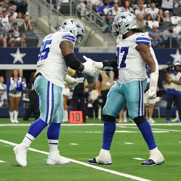 Dallas Cowboys defensive tackles Kenny Clark and Osa Odighizuwa celebrate a sack against the New York Giants 