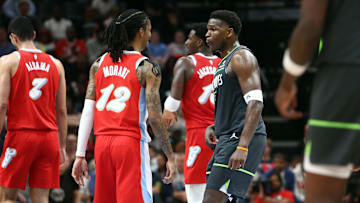 Apr 10, 2025; Memphis, Tennessee, USA; Minnesota Timberwolves guard Anthony Edwards (5) reacts toward Memphis Grizzlies guard Ja Morant (12) at the end of the first half at FedExForum. Mandatory Credit: Petre Thomas-Imagn Images