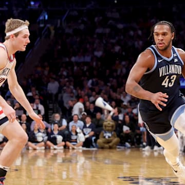 Mar 13, 2025; New York, NY, USA; Villanova Wildcats forward Eric Dixon (43) drives to the basket against Connecticut Huskies forward Liam McNeeley (30) during the first half at Madison Square Garden. Mandatory Credit: Brad Penner-Imagn Images