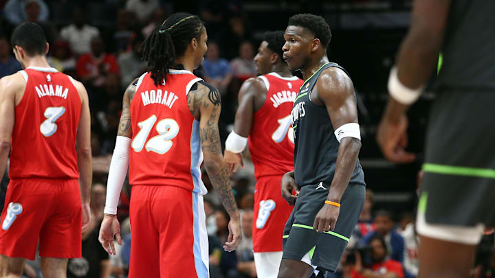 Apr 10, 2025; Memphis, Tennessee, USA; Minnesota Timberwolves guard Anthony Edwards (5) reacts toward Memphis Grizzlies guard Ja Morant (12) at the end of the first half at FedExForum. Mandatory Credit: Petre Thomas-Imagn Images