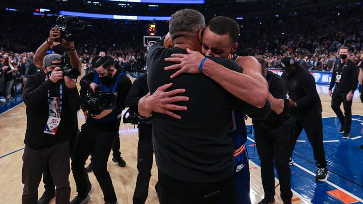 Dec 14, 2021; New York, New York, USA; Golden State Warriors guard Stephen Curry (30) hugs his father Dell Curry (left) after breaking the record for most career three point baskets made during the first half against the New York Knicks at Madison Square Garden. Mandatory Credit: Vincent Carchietta-Imagn Images