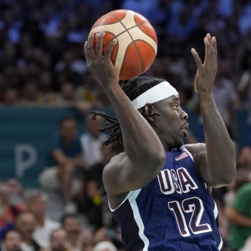 Jul 28, 2024; Villeneuve-d'Ascq, France; United States guard Jrue Holiday (12) passes in the first quarter against Serbia during the Paris 2024 Olympic Summer Games at Stade Pierre-Mauroy. Mandatory Credit: John David Mercer-USA TODAY Sports