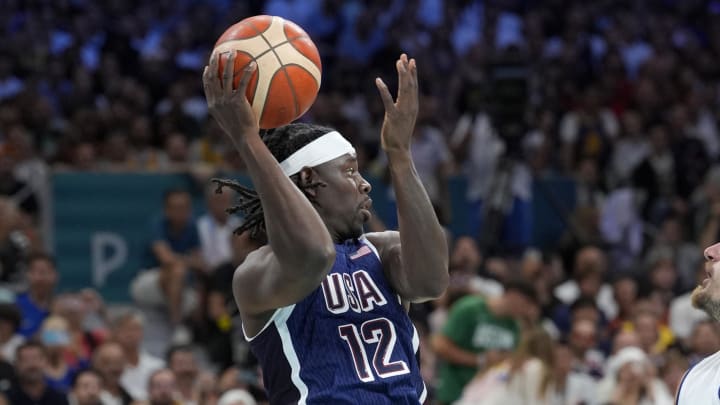 Jul 28, 2024; Villeneuve-d'Ascq, France; United States guard Jrue Holiday (12) passes in the first quarter against Serbia during the Paris 2024 Olympic Summer Games at Stade Pierre-Mauroy. Mandatory Credit: John David Mercer-USA TODAY Sports