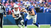 Dec 31, 2023; Orchard Park, NY; Buffalo Bills tight end Dalton Kincaid (86) turns up field after a catch in front of New England Patriots safety Kyle Dugger (23) in the first quarter at Highmark Stadium.  