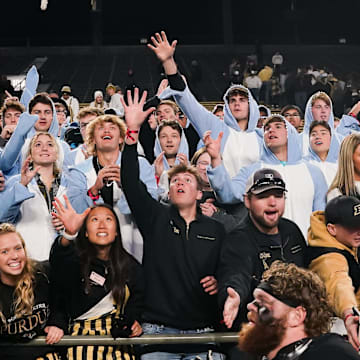 Fans reach for a player   s pair of gloves thrown into the crowd 