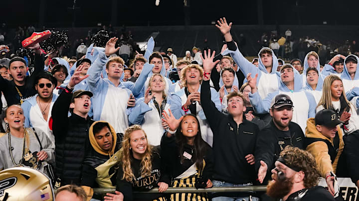 Fans reach for a player   s pair of gloves thrown into the crowd 