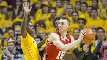 Mar 5, 2015; Minneapolis, MN, USA; Wisconsin Badgers forward Sam Dekker (15) looks to pass the ball around Minnesota Golden Gophers guard Carlos Morris (11) in the second half at Williams Arena. The Badgers won 76-63. Mandatory Credit: Jesse Johnson-Imagn Images