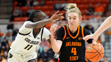 Oklahoma State guard Anna Gret Asi (4) drives to the basket as Colorado forward Nyamer Diew (11) defends during the college basketball game between the Oklahoma State University Cowgirls and the Colorado Buffaloes, Saturday, Feb., 22, 2025.
