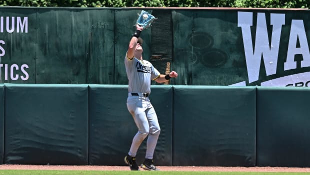 Oregon outfielder Bryce Boettcher catches a fly ball off of Texas A&M outfielder Jace LaViolette for an out.