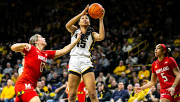 Iowa forward Hannah Stuelke, center, shoots the ball as Maryland's Faith Masonius, left, and Brinae Alexander defend during a NCAA Big Ten Conference women's basketball game, Thursday, Feb. 2, 2023, at Carver-Hawkeye Arena in Iowa City, Iowa.