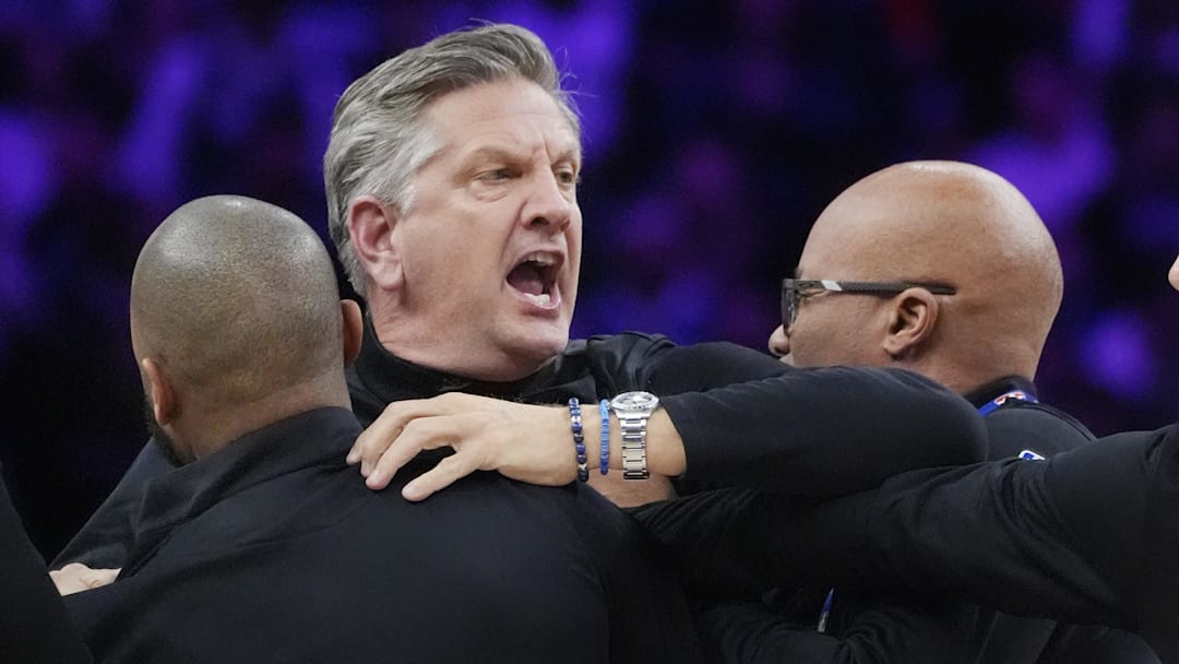 Dec 19, 2025; Minneapolis, Minnesota, USA; Staff restrains Minnesota Timberwolves head coach Chris Finch after a referee ejected him for chasing him down on a call for the Oklahoma City Thunder in the first quarter at Target Center. Mandatory Credit: Bruce Kluckhohn-Imagn Images
