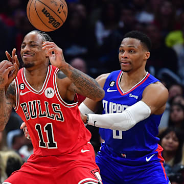 Mar 27, 2023; Los Angeles, California, USA; Chicago Bulls forward DeMar DeRozan (11) loses the ball against Los Angeles Clippers forward Kawhi Leonard (2) and guard Russell Westbrook (0) during the second half at Crypto.com Arena. 