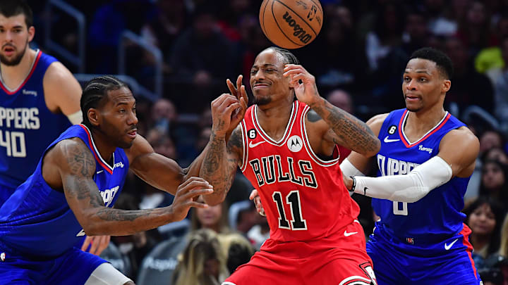 Mar 27, 2023; Los Angeles, California, USA; Chicago Bulls forward DeMar DeRozan (11) loses the ball against Los Angeles Clippers forward Kawhi Leonard (2) and guard Russell Westbrook (0) during the second half at Crypto.com Arena. 