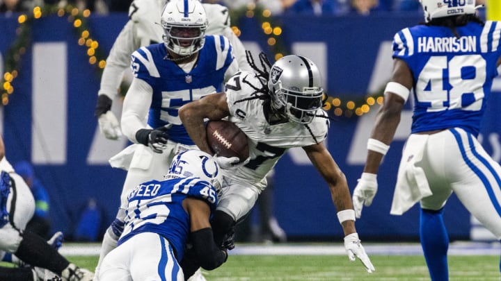 Dec 31, 2023; Indianapolis, Indiana, USA; Las Vegas Raiders wide receiver Davante Adams (17) runs the ball while Indianapolis Colts linebacker E.J. Speed (45) defends in the first half at Lucas Oil Stadium. Mandatory Credit: Trevor Ruszkowski-USA TODAY Sports