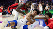 Nov 27, 2024; Philadelphia, Pennsylvania, USA; Philadelphia 76ers guard Jared McCain (20) controls a loose ball against Houston Rockets forward Tari Eason (17) and forward Amen Thompson (1) during the fourth quarter at Wells Fargo Center. Mandatory Credit: Bill Streicher-Imagn Images