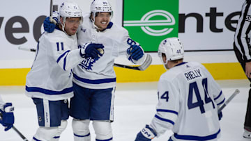 Feb 10, 2024; Ottawa, Ontario, CAN; Toronto Maple Leafs cente Max Domi (11) celebrates with left wing Nicholas Robertson (89) and defenseman Morgan Rielly (44) his goal scored in the third period against the Ottawa Senators at the Canadian Tire Centre. Mandatory Credit: Marc DesRosiers-Imagn Images