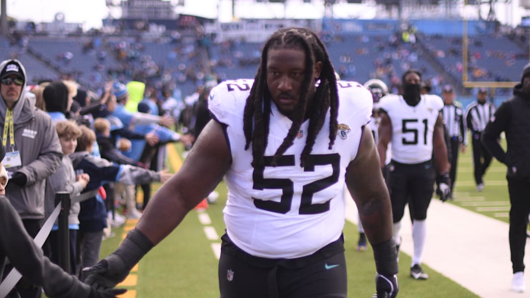 Nov 30, 2025; Nashville, Tennessee, USA; Jacksonville Jaguars defensive tackle DaVon Hamilton (52) low fives fans as he leaves the field prior to a game against the Tennessee Titans
at Nissan Stadium. Mandatory Credit: Steve Roberts-Imagn Images