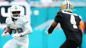 Nov 30, 2025; Miami Gardens, Florida, USA; Miami Dolphins running back De'Von Achane (28) carries the ball against the New Orleans Saints during the first half at Hard Rock Stadium. Mandatory Credit: Rich Storry-Imagn Images