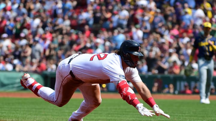 May 26, 2024; Boston, Massachusetts, USA;  Boston Red Sox right fielder Wilyer Abreu (52) slides into third base for a triple during the fourth inning against the Milwaukee Brewers at Fenway Park. Mandatory Credit: Bob DeChiara-USA TODAY Sports