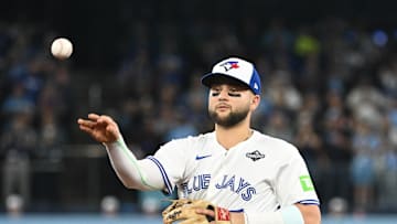 Oct 24, 2025; Toronto, Ontario, CAN; Toronto Blue Jays second baseman Bo Bichette (11) makes a play to get out Los Angeles Dodgers first baseman Freddie Freeman (not pictured) in the first inning during game one of the 2025 MLB World Series at Rogers Centre. Mandatory Credit: Dan Hamilton-Imagn Images