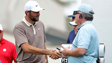 Mar 30, 2025; Houston, Texas, USA; Scottie Scheffler shakes hands with a steward prior to teeing off at the first hole during the final round of the Texas Children's Houston Open golf tournament. Mandatory Credit: Erik Williams-Imagn Images