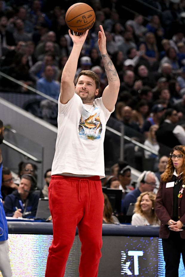Dallas Mavericks guard Luka Doncic takes a practice shot during a stoppage in play against the Oklahoma City Thunder  