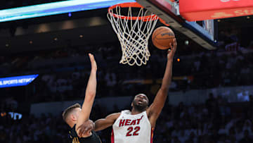 Apr 26, 2025; Miami, Florida, USA;Miami Heat forward Andrew Wiggins (22) drives to the basket against Cleveland Cavaliers guard Sam Merrill (5) in the third quarter during game three for the first round of the 2025 NBA Playoffs at Kaseya Center. Mandatory Credit: Sam Navarro-Imagn Images