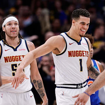Mar 21, 2024; Denver, Colorado, USA; Denver Nuggets forward Michael Porter Jr. (1) reacts with guard Jamal Murray (27) ahead of forward Aaron Gordon (50) in the fourth quarter against the New York Knicks at Ball Arena. Mandatory Credit: Isaiah J. Downing-Imagn Images