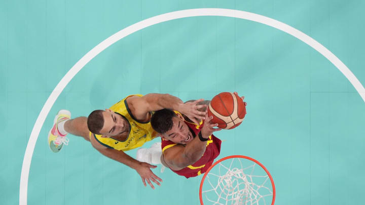 Jul 27, 2024; Villeneuve-d'Ascq, France; Spain centre Willy Hernangomez (14) battles with Australia small forward Jack McVeigh (17) for the ball in men's Group A play during the Paris 2024 Olympic Summer Games at Stade Pierre-Mauroy. Mandatory Credit: John David Mercer-USA TODAY Sports