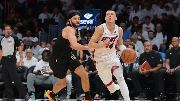 Apr 26, 2025; Miami, Florida, USA; Miami Heat guard Tyler Herro (14) drives to the basket past Cleveland Cavaliers guard Max Strus (1) in the third quarter during game three for the first round of the 2025 NBA Playoffs at Kaseya Center. Mandatory Credit: Sam Navarro-Imagn Images