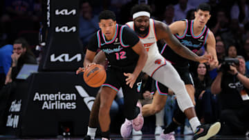 Nov 17, 2025; Miami, Florida, USA; Miami Heat guard Dru Smith (12) dribbles the basketball against New York Knicks center Mitchell Robinson (23) during the first quarter at Kaseya Center. Mandatory Credit: Sam Navarro-Imagn Images