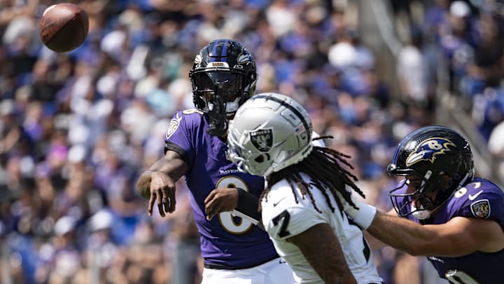 Sep 15, 2024; Baltimore, Maryland, USA;  Baltimore Ravens quarterback Lamar Jackson (8) throws over Las Vegas Raiders safety Tre'von Moehrig (7) during the  first half at M&T Bank Stadium. Mandatory Credit: Tommy Gilligan-Imagn Images