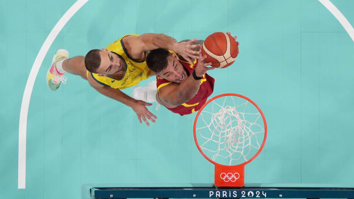 Jul 27, 2024; Villeneuve-d'Ascq, France; Spain centre Willy Hernangomez (14) battles with Australia small forward Jack McVeigh (17) for the ball in men's Group A play during the Paris 2024 Olympic Summer Games at Stade Pierre-Mauroy.