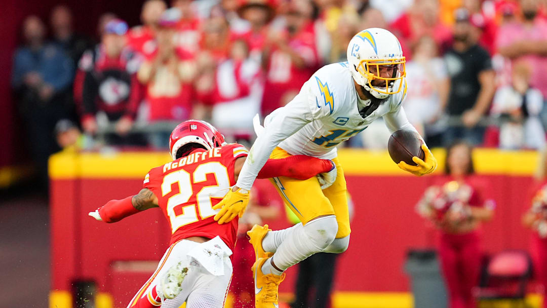 Oct 22, 2023; Kansas City, Missouri, USA; Los Angeles Chargers wide receiver Keenan Allen (13) is tackled by Kansas City Chiefs cornerback Trent McDuffie (22) during the second half at GEHA Field at Arrowhead Stadium. Mandatory Credit: Jay Biggerstaff-Imagn Images