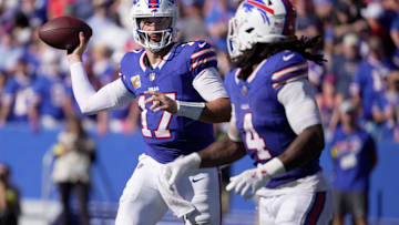 Buffalo Bills quarterback Josh Allen looks at running back James Cook as he launches a short pass to him during second-half action of the Bills' home game against the New Orleans Saints.