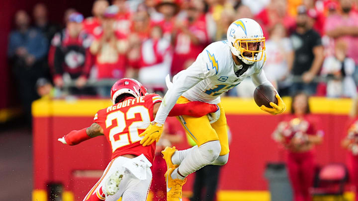 Oct 22, 2023; Kansas City, Missouri, USA; Los Angeles Chargers wide receiver Keenan Allen (13) is tackled by Kansas City Chiefs cornerback Trent McDuffie (22) during the second half at GEHA Field at Arrowhead Stadium. Mandatory Credit: Jay Biggerstaff-Imagn Images