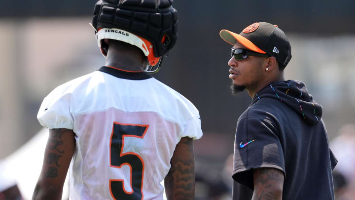 Jul 26, 2024; Cincinnati, OH, USA; Cincinnati Bengals wide receiver Ja'Marr Chase (right) talks with wide receiver Tee Higgins (5) during training camp practice at Kettering Health Practice Fields. Mandatory Credit: Kareem Elgazzar-USA TODAY Sports