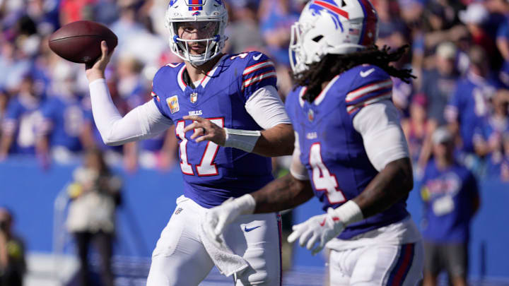 Buffalo Bills quarterback Josh Allen looks at running back James Cook as he launches a short pass to him during second half action of the Bills home game against the New Orleans Saints in Orchard Park on Sept. 28, 2025.
