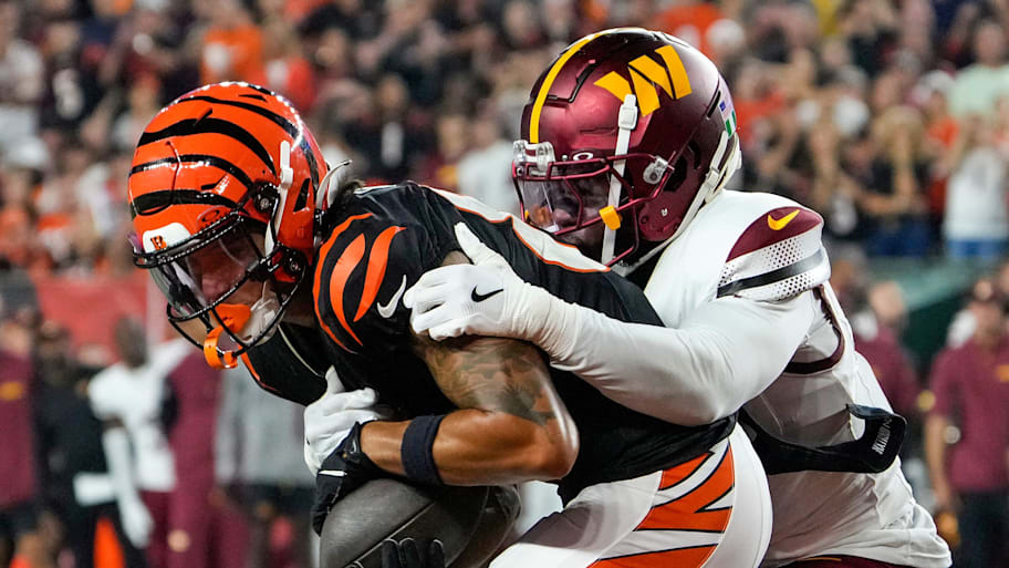 Cincinnati Bengals wide receiver Andrei Iosivas makes a touchdown over Washington Commanders cornerback Noah Igbinoghene. | Cara Owsley/The Enquirer / USA TODAY NETWORK via Imagn Images