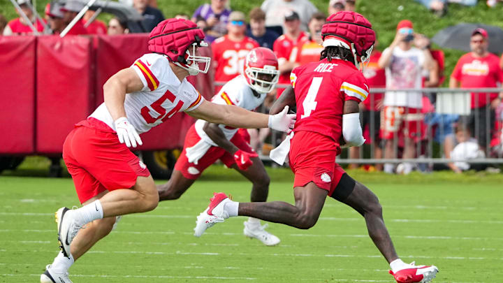 Jul 22, 2025; St. Joseph, MO, USA; Kansas City Chiefs wide receiver Rashee Rice (4) catches a pass as linebacker Leo Chenal (54) defends during training camp at Missouri Western State University. Mandatory Credit: Denny Medley-Imagn Images