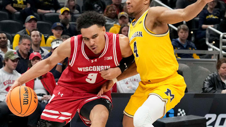 Michigan Wolverines guard Nimari Burnett (4) guards Wisconsin Badgers guard John Tonje (9) during the first half of the 2025 TIAA Big Ten Men’s Basketball Tournament final game on Sunday, March 16, 2025, at Gainbridge Fieldhouse in Indianapolis.