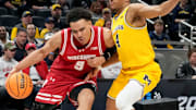 Michigan Wolverines guard Nimari Burnett (4) guards Wisconsin Badgers guard John Tonje (9) during the first half of the 2025 TIAA Big Ten Men’s Basketball Tournament final game on Sunday, March 16, 2025, at Gainbridge Fieldhouse in Indianapolis.