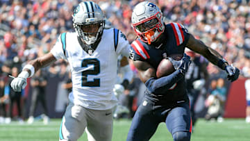 New England Patriots wide receiver Stefon Diggs (8) runs the ball while Carolina Panthers cornerback Mike Jackson (2) defends during the first half at Gillette Stadium.