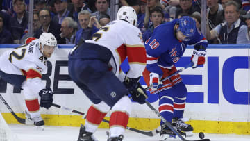May 22, 2024; New York, New York, USA; New York Rangers left wing Artemi Panarin (10) fights for the puck against Florida Panthers defenseman Gustav Forsling (42) and center Aleksander Barkov (16) during the third period of game one of the Eastern Conference Final of the 2024 Stanley Cup Playoffs at Madison Square Garden. Mandatory Credit: Brad Penner-USA TODAY Sports