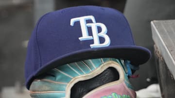 Sep 26, 2025; Toronto, Ontario, CAN; The hat and glove of Tampa Bay Rays third baseman Junior Caminero (13) in the dugout during the game against the Toronto Blue Jays at Rogers Centre. 