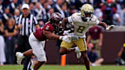 Oct 26, 2024; Blacksburg, Virginia, USA; Georgia Tech Yellow Jackets wide receiver Malik Rutherford (8) runs the ball against Virginia Tech Hokies linebacker Sam Brumfield (3) during the third quarter at Lane Stadium. Mandatory Credit: Peter Casey-Imagn Images