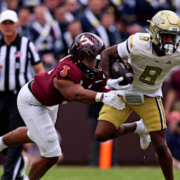 Oct 26, 2024; Blacksburg, Virginia, USA; Georgia Tech Yellow Jackets wide receiver Malik Rutherford (8) runs the ball against Virginia Tech Hokies linebacker Sam Brumfield (3) during the third quarter at Lane Stadium. Mandatory Credit: Peter Casey-Imagn Images