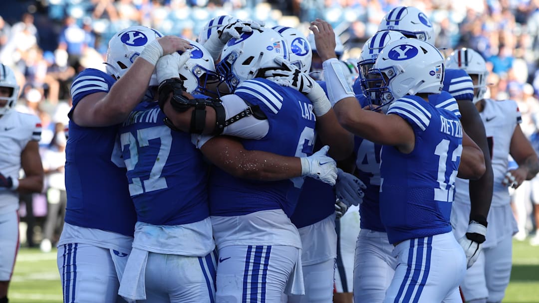 Oct 12, 2024; Provo, Utah, USA; The Brigham Young Cougars celebrate a touchdown by running back LJ Martin (27) against the Arizona Wildcats during the fourth quarter at LaVell Edwards Stadium. Mandatory Credit: Rob Gray-Imagn Images