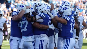 Oct 12, 2024; Provo, Utah, USA; The Brigham Young Cougars celebrate a touchdown by running back LJ Martin (27) against the Arizona Wildcats during the fourth quarter at LaVell Edwards Stadium. Mandatory Credit: Rob Gray-Imagn Images